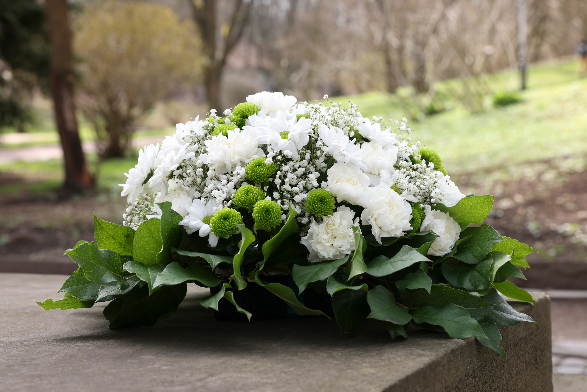 Funeral Wreath of Flowers on Tombstone Outdoors